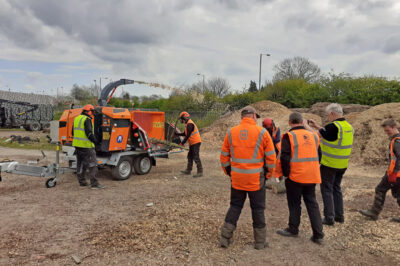 Towable turntable chipper speeds highway tree works