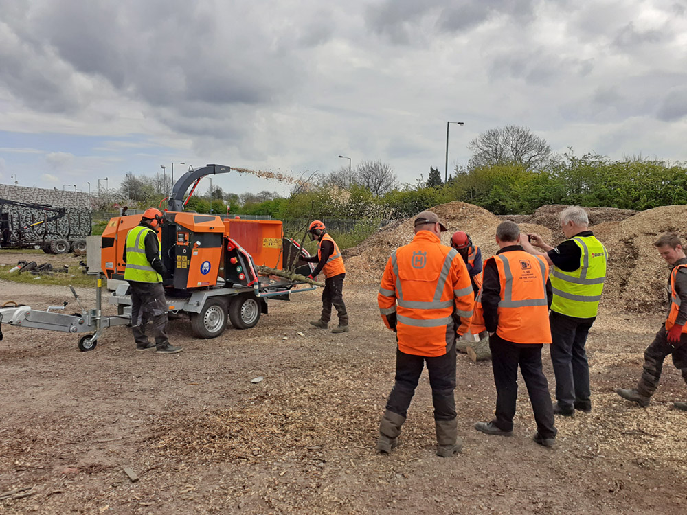 Towable turntable chipper speeds highway tree works