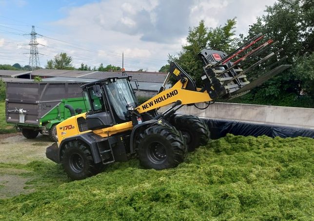 New Holland W170D Wheel Loader driving up Silage Clamp